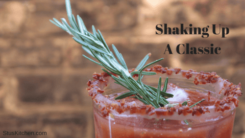 Spicy Bloody Mary cocktail in a tall glass with a celery garnish