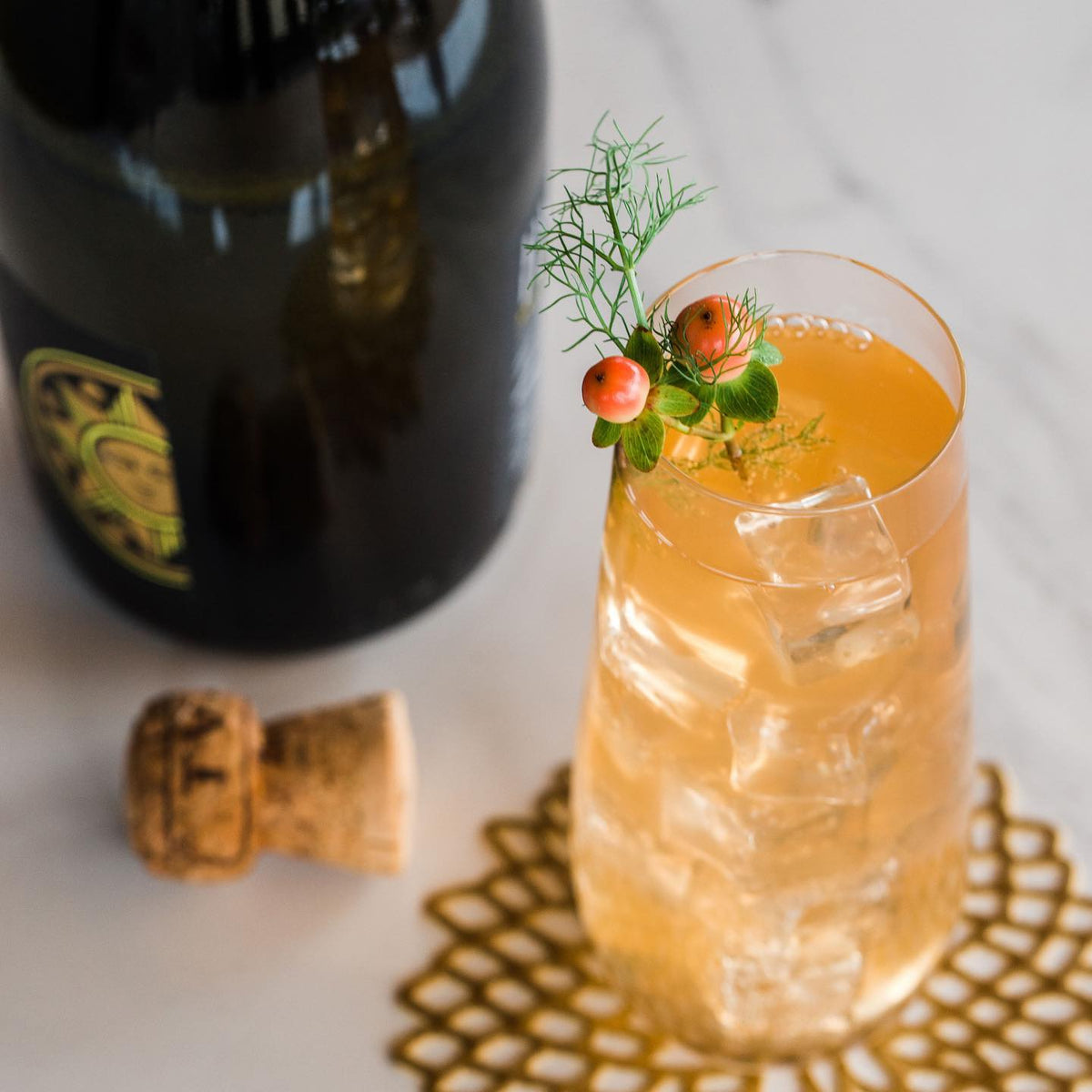 Spritzer Italiano made with Jo's Orange Fennel tonic syrup and Prosecco over ice, garnished with fennel fronds