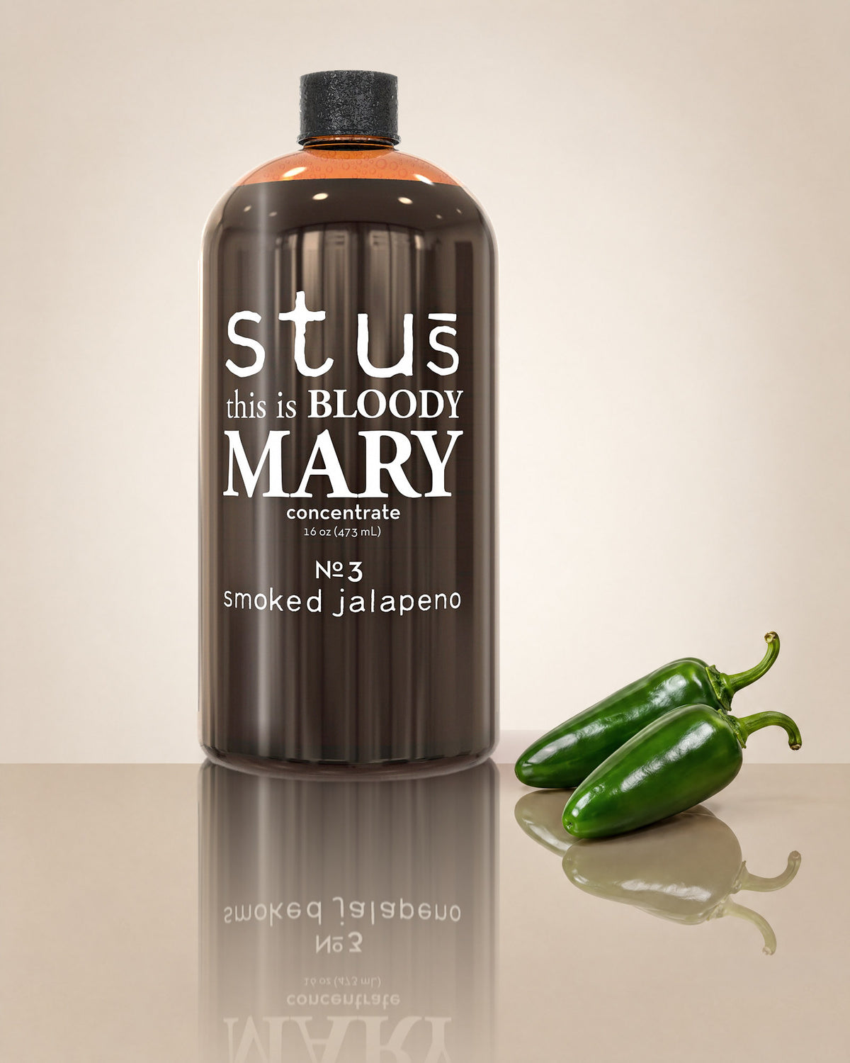 Stu's Smoked Jalapeño No. 3 Bloody Mary seasoning bottle with fresh green jalapeño peppers on a cream background