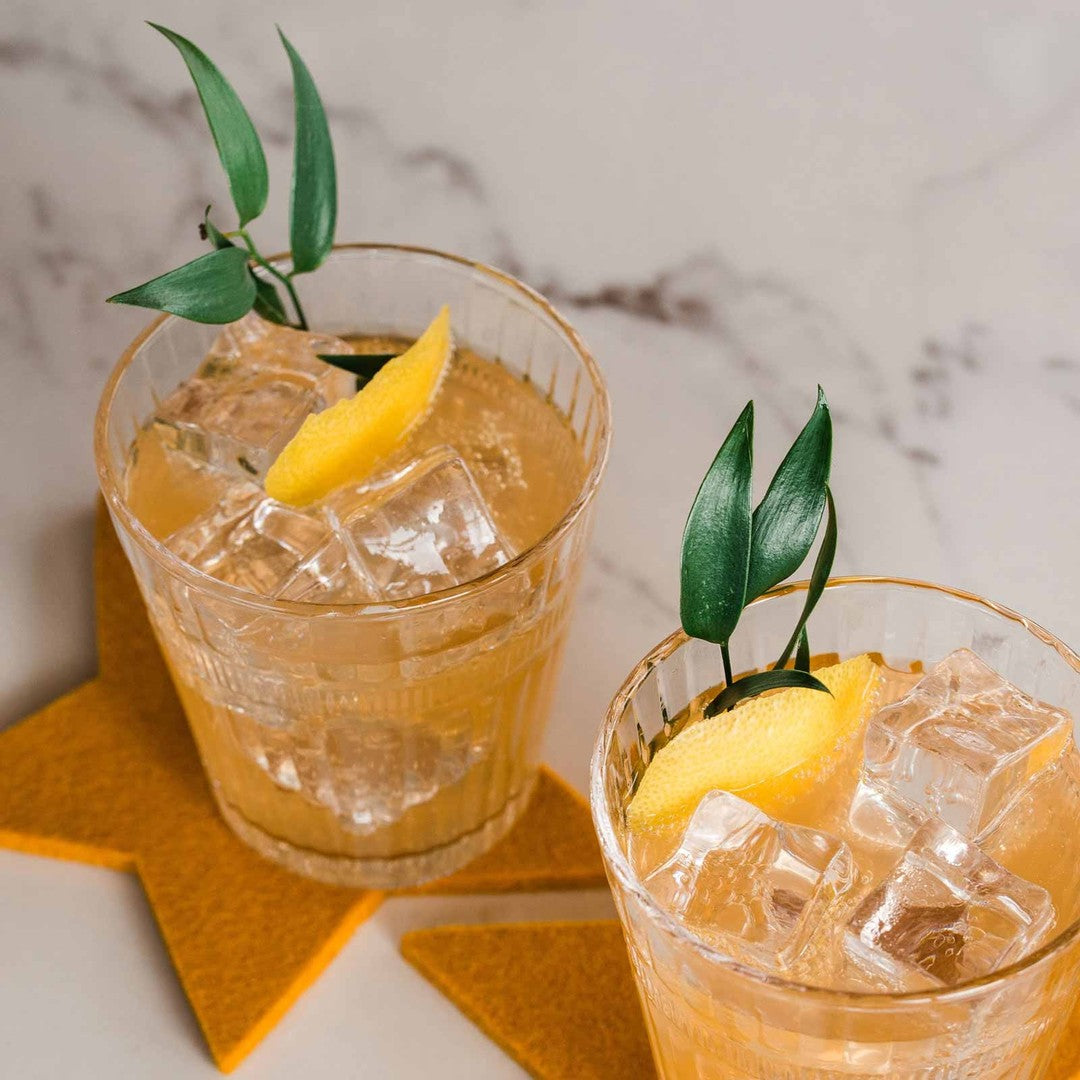 Coconut mocktail made with Jo's Original tonic syrup and coconut sparkling water, over ice with a lemon twist