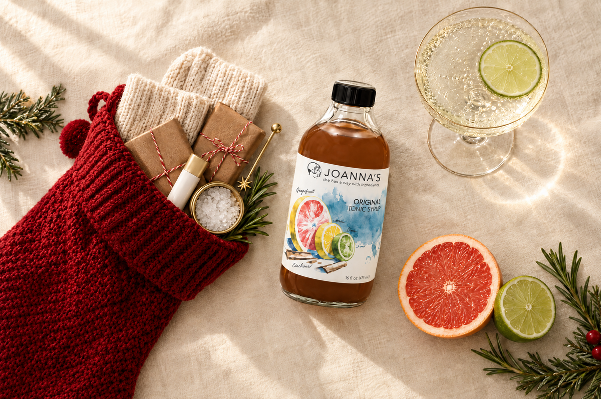 Stocking stuffers for women: Jo's Original tonic syrup, a red knit stocking with cozy socks, sea salt, lip balm, and a sparkling tonic with lime