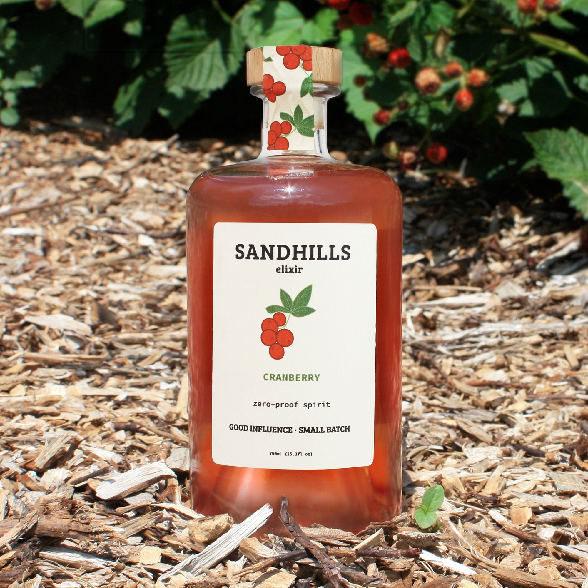 Cranberry zero-proof spirit bottle in a Nebraska prairie setting