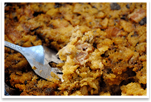 A fork is being used to take a bite out of a casserole.